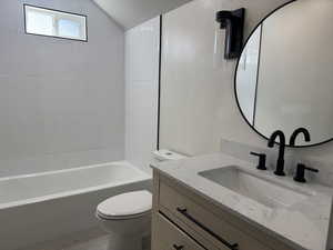 Bathroom with vanity, shower / tub combination, tile patterned floors, and lofted ceiling