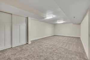 Finished below grade area featuring carpet and a textured ceiling