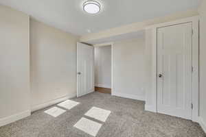 Unfurnished bedroom with baseboards and carpet floors