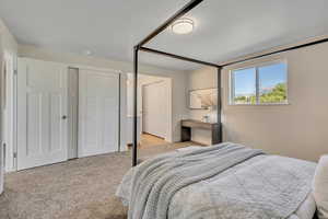 Carpeted bedroom featuring two closets and baseboards