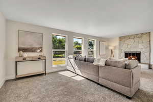 Living area featuring carpet floors and a fireplace