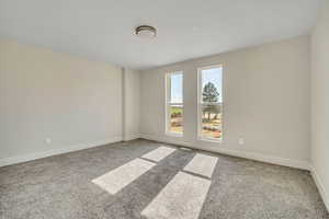 Carpeted empty room with baseboards