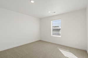 Spare room with light colored carpet and recessed lighting