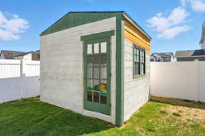 View of shed with a fenced backyard