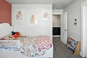 Carpeted bedroom with a textured ceiling