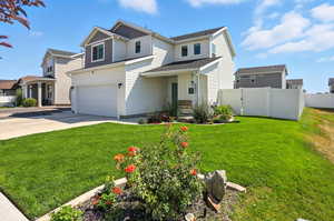 View of front of house with driveway, board and batten siding, and an attached garage