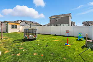 Fenced backyard with a residential view