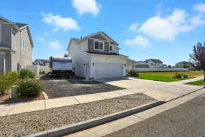 Traditional-style house with concrete driveway, a residential view, an attached garage, and board and batten siding