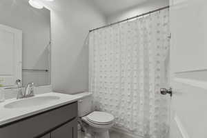 Full bath with vanity, shower / bath combination with curtain, and tile patterned floors