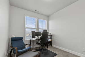 Office space with carpet and baseboards