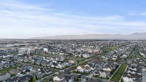 Aerial overview of property's location featuring a mountain backdrop and nearby suburban area