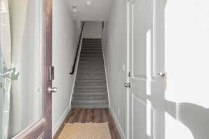 Stairs featuring baseboards and wood finished floors