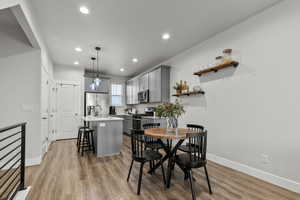 Dining room featuring light wood finished floors and recessed lighting