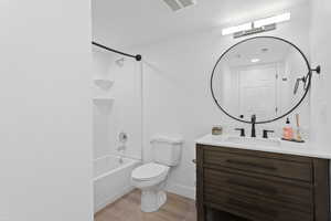 Alternative hallway bathroom featuring vanity, LVP floors, and shower / bathtub combination.
