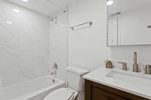 Main full bath attached to main bedroom with vanity and shower / washtub combination.