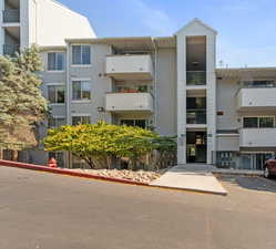 View of apartment building / complex featuring  parking. This unit comes with 1 covered and 2 uncovered parking spots.