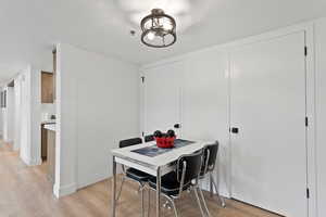 Dining space with light wood-style floors with the HVAC and pantry to the side of it.