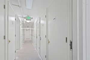 Corridor featuring concrete floors leading to storage units.