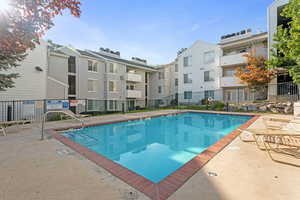 Community pool with a patio