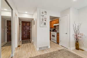 Entrance foyer featuring light wood-style floors and recessed lighting