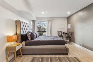 Bedroom with wood finished floors and recessed lighting