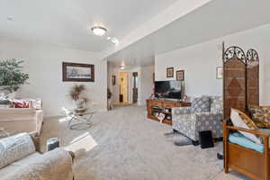 Carpeted living room with baseboards