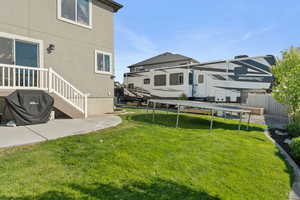 View of yard featuring a trampoline