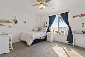 Bedroom with light colored carpet and a ceiling fan