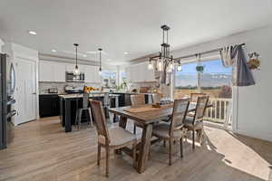 Dining space featuring a mountain view, light wood finished floors, plenty of natural light, and recessed lighting