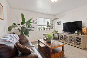 Living area with carpet flooring and baseboards
