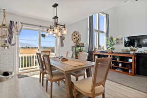 Dining space with wood finished floors, a chandelier, and a mountain view