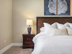 Carpeted bedroom with baseboards