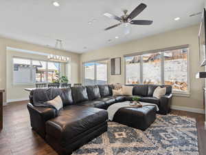 Living area featuring wood finished floors, recessed lighting, ceiling fan, and a chandelier