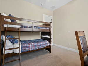 Bedroom with carpet flooring and baseboards