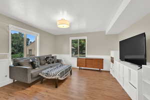 Living room featuring light wood-style floors and a textured ceiling