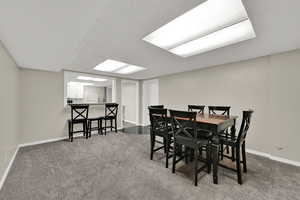 Dining room with carpet and a paneled ceiling