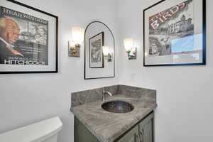 Half bathroom with vanity and toilet
