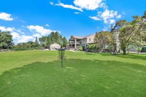 View of property's community with a lawn