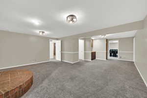 Finished below grade area with carpet flooring and baseboards