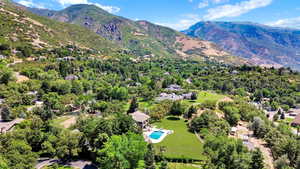Drone / aerial view of a mountainous background and a pool