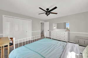 Bedroom with a closet and a ceiling fan