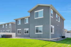 Rear view of property with a patio area, a hot tub, and stucco siding