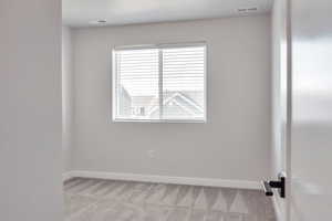 Unfurnished room with light carpet