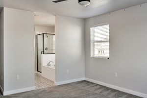 Spare room featuring light colored carpet and ceiling fan