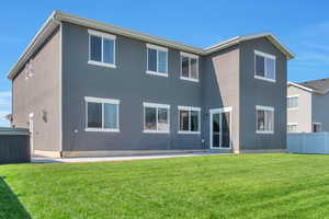 Back of property with stucco siding and a patio area