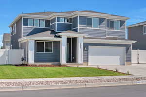 View of front facade featuring a gate, a garage, concrete driveway, and a shingled roof