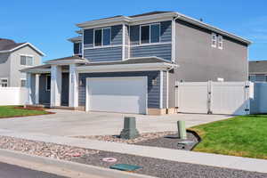 View of front of property featuring a garage and driveway