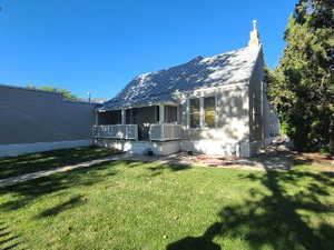 View of front of property with a front yard and a chimney
