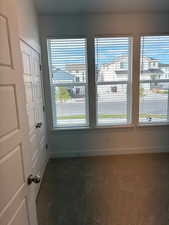 Spare room featuring dark carpet