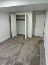 Unfurnished bedroom featuring carpet floors and a closet
